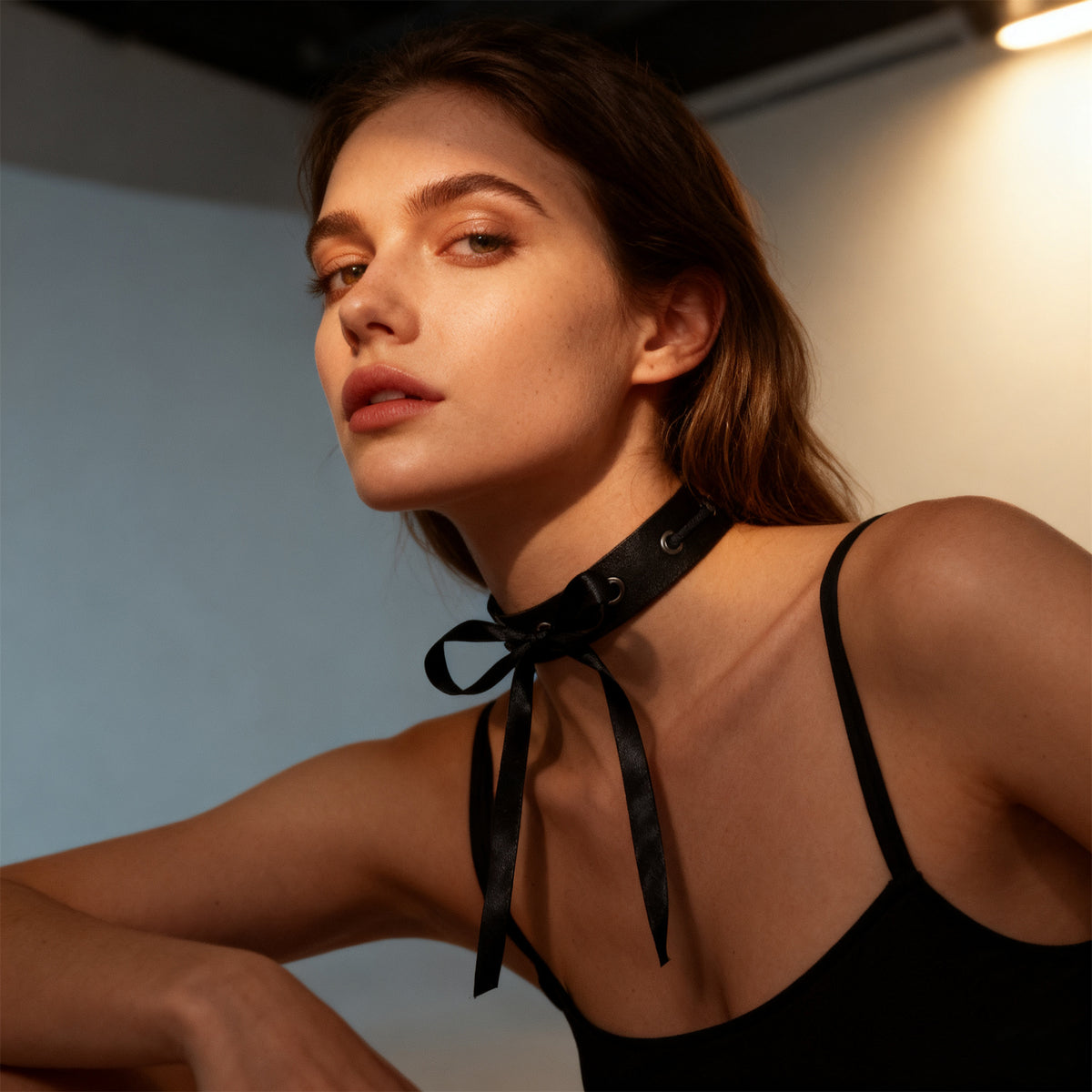Black choker with ribbon ties and grommet eyelets with open-back dress straps