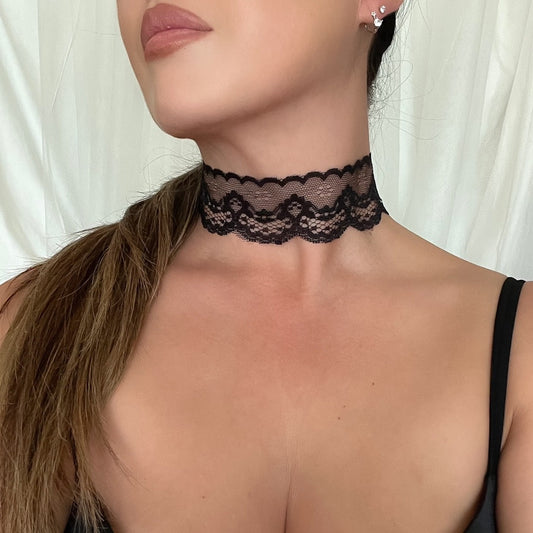 Black lace choker with scalloped edge, worn around the neck