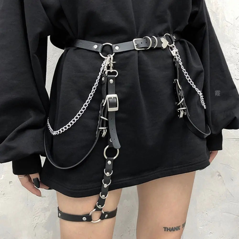 Black short dress with layered chain harness belt and metal rings