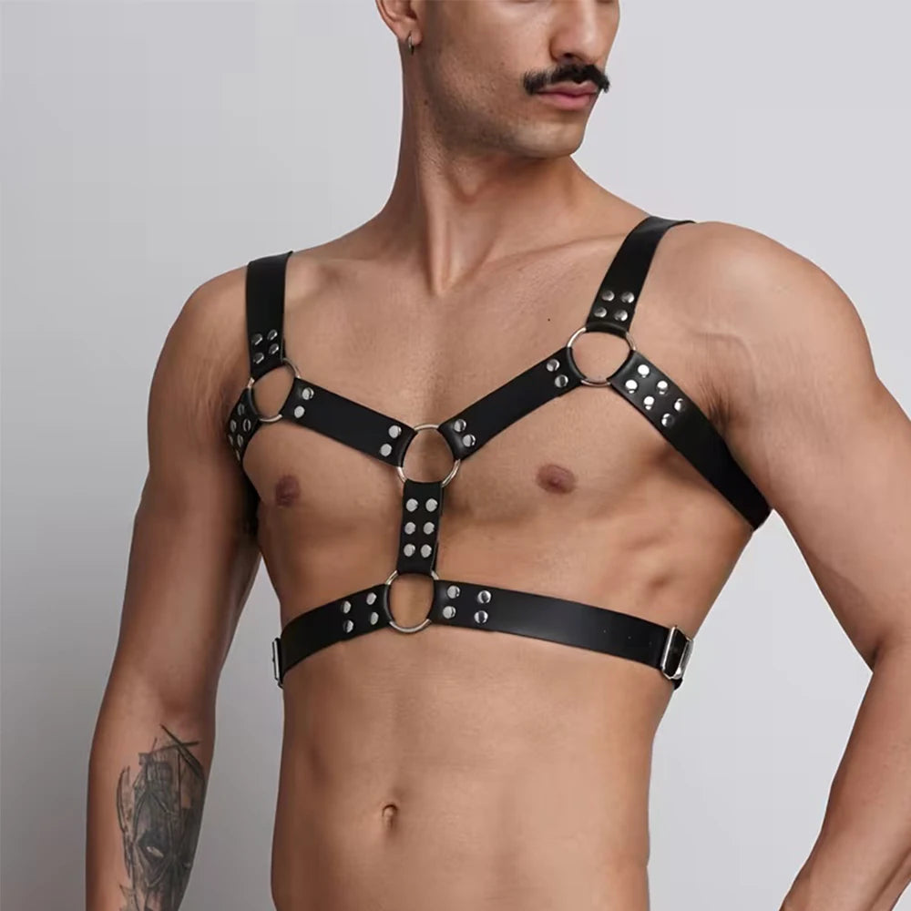 Black studded chest harness belt with circular metal rings and adjustable straps