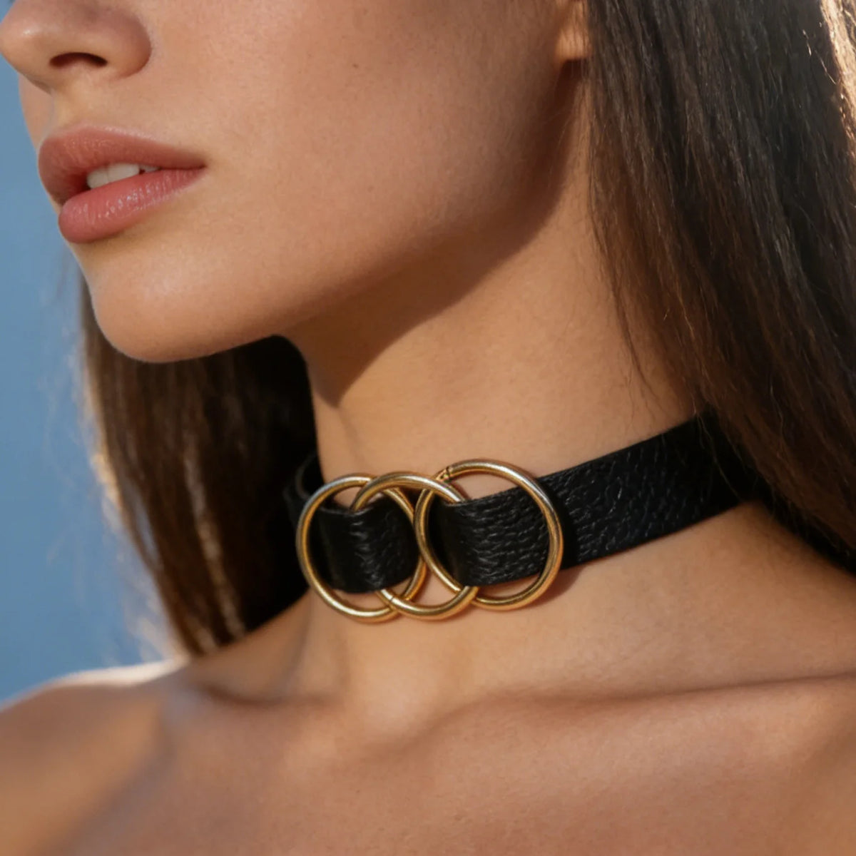 Black leather choker with three gold-tone interlocking rings