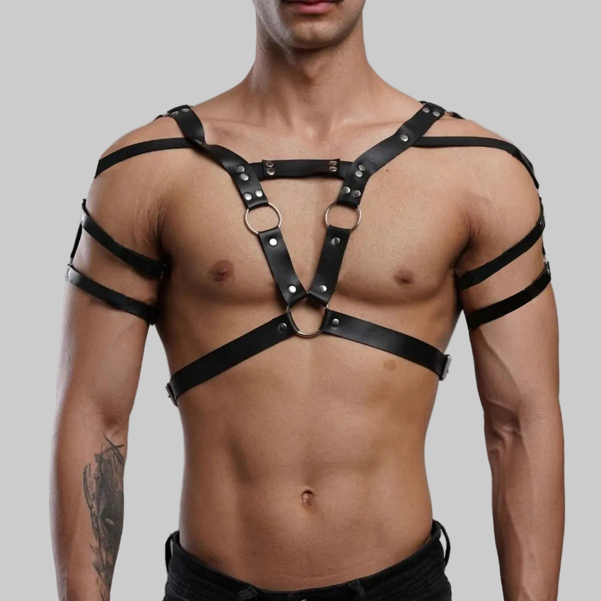 Black leather chest harness with V-shaped straps, metal rings, and shoulder bands
