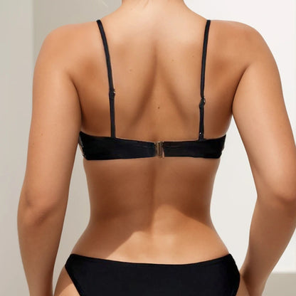 Black one-piece lingerie with strappy back and center metal clasp closure