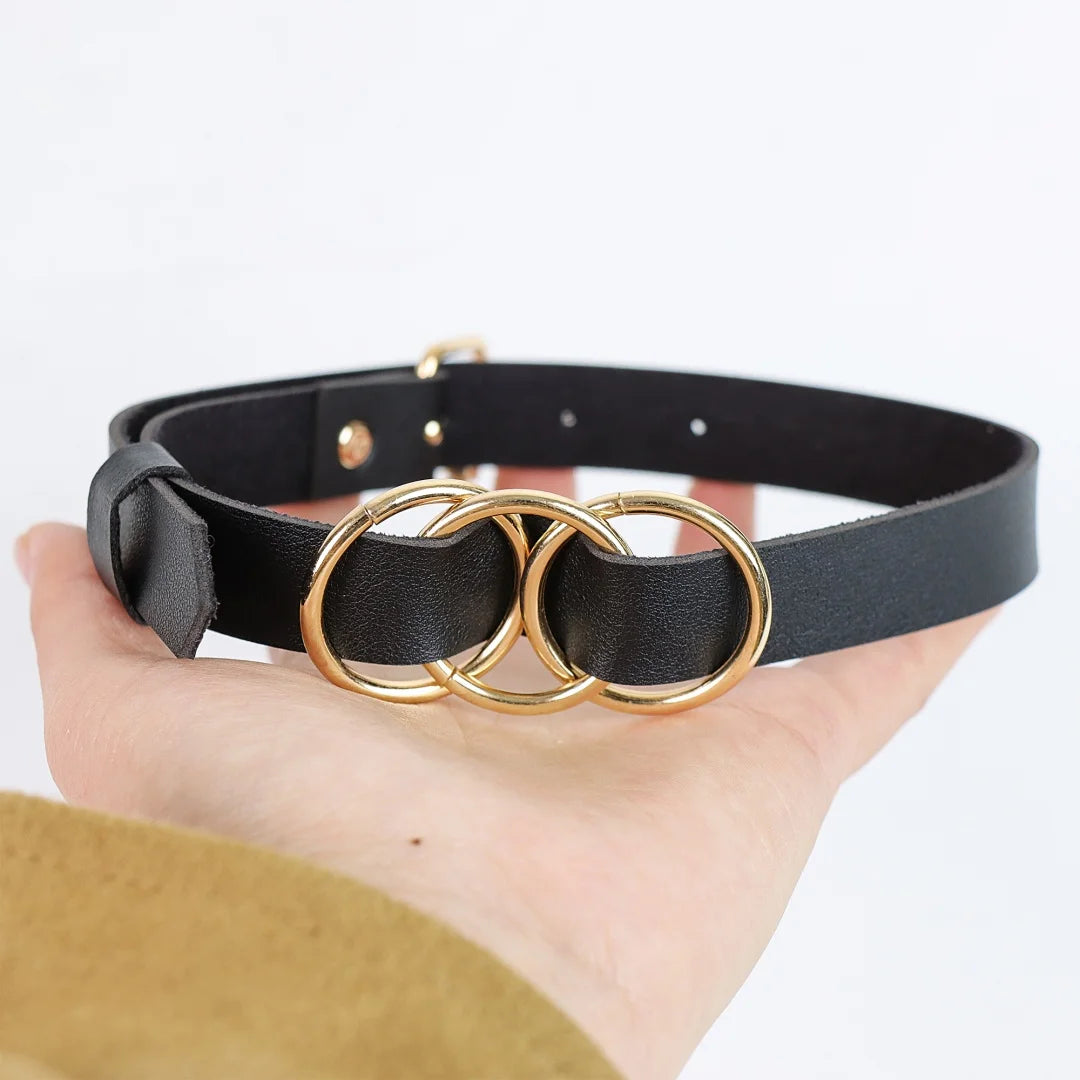 Black leather choker strap with gold-tone three-ring centerpiece