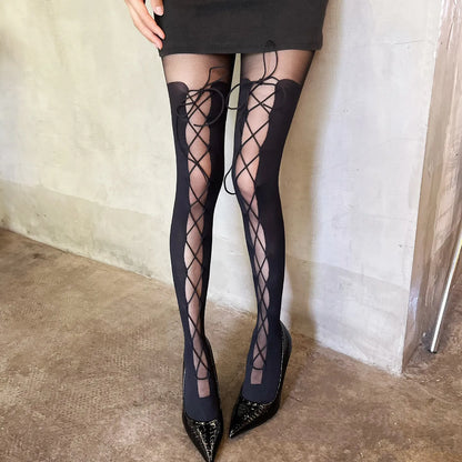 Black thigh-high lace-up boots with crisscross lacing and pointed glitter toe tips