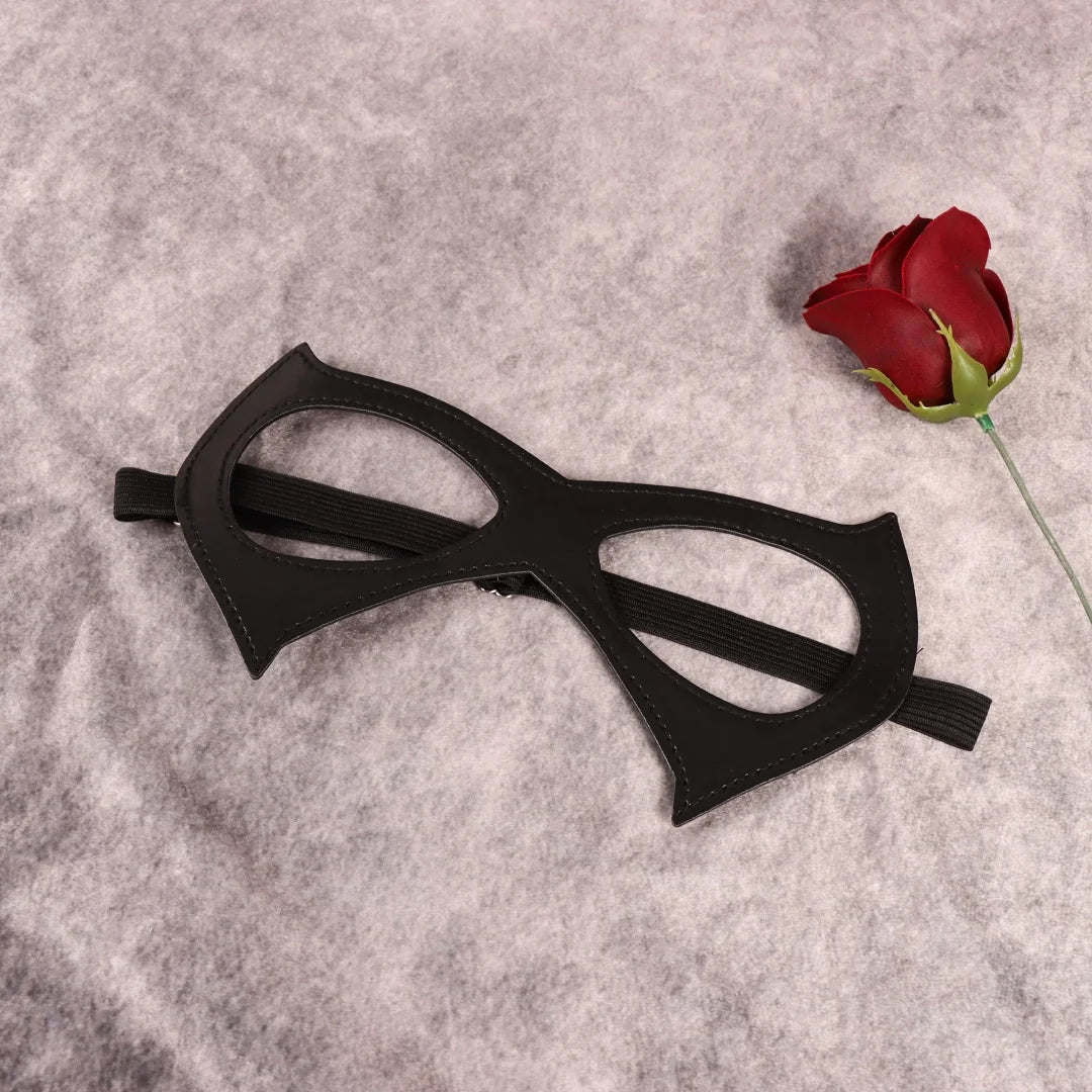 Black cat-eye masquerade mask with pointed tips, stitched edges, elastic side straps