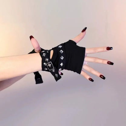 Black fingerless arm/hand warmers with pyramid studs and ribbon ties, worn on wrists