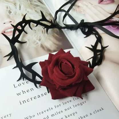 Red rose charm necklace with black gothic metal motifs and ribbon-like ties