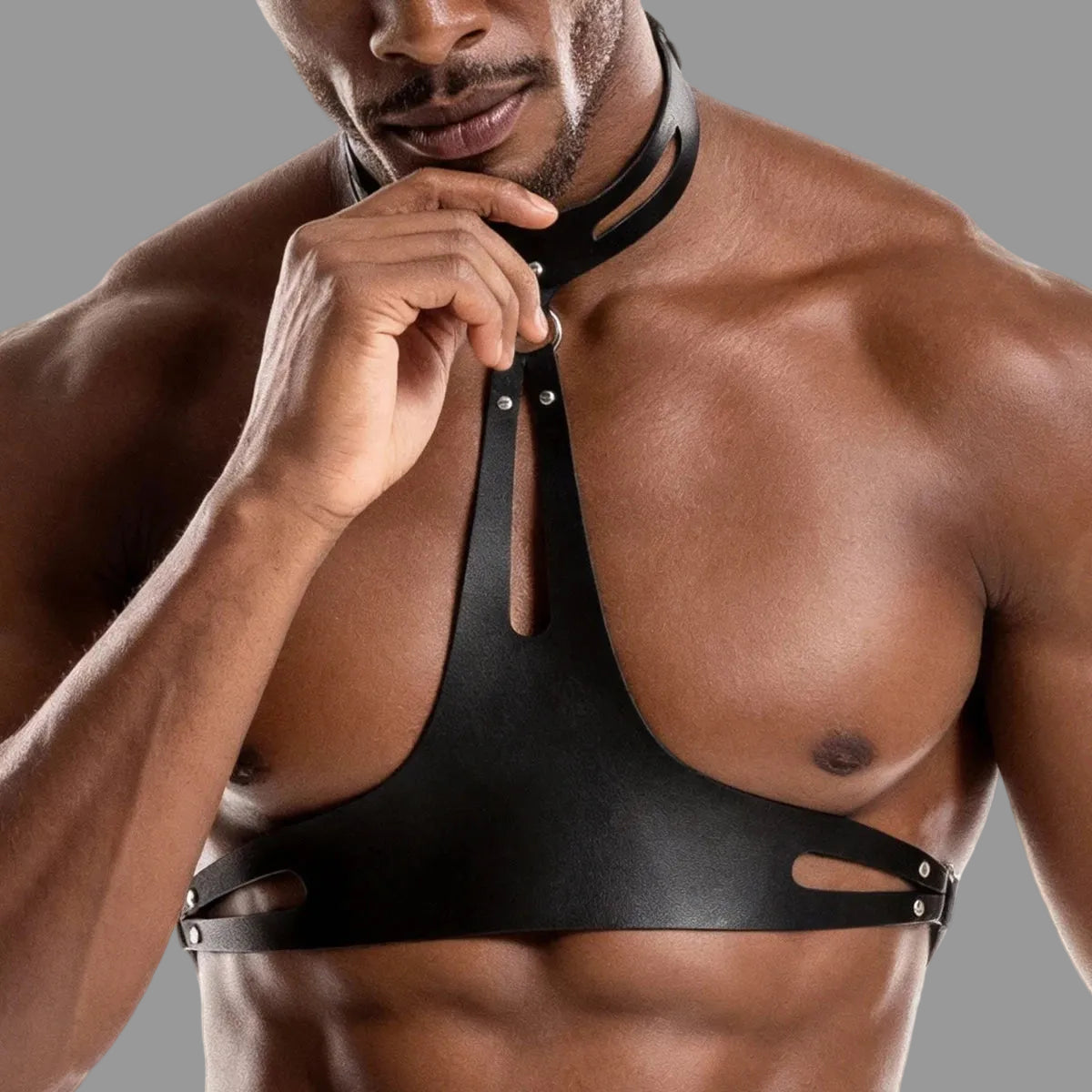 Black leather harness bra with halter neck strap and dangling front leather tab
