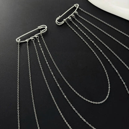 Set of layered silver chain drape necklaces with carabiner-style clasps, flat lay