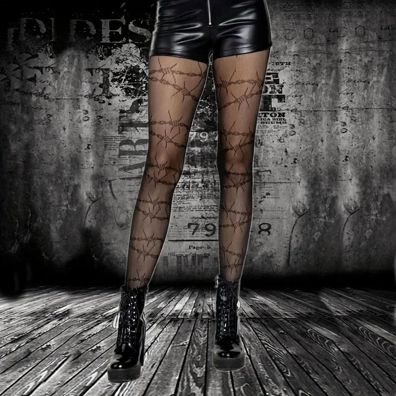 Sheer tights with dark geometric pattern, worn with black shorts and boots