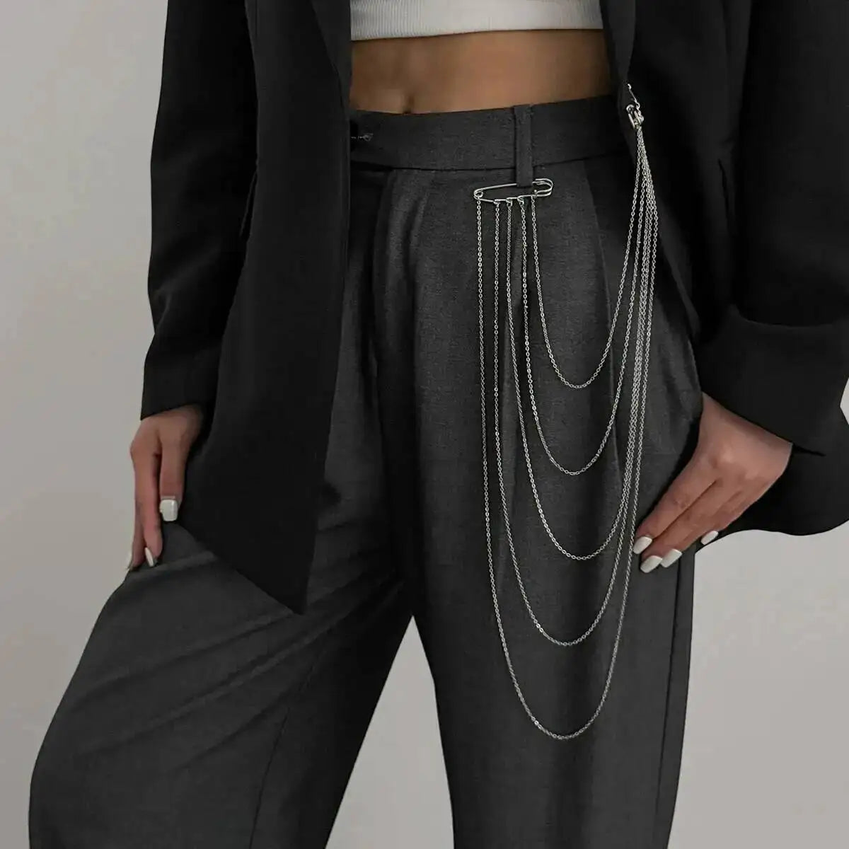 Layered silver chain drape belt with long dangling chains, worn over dark trousers
