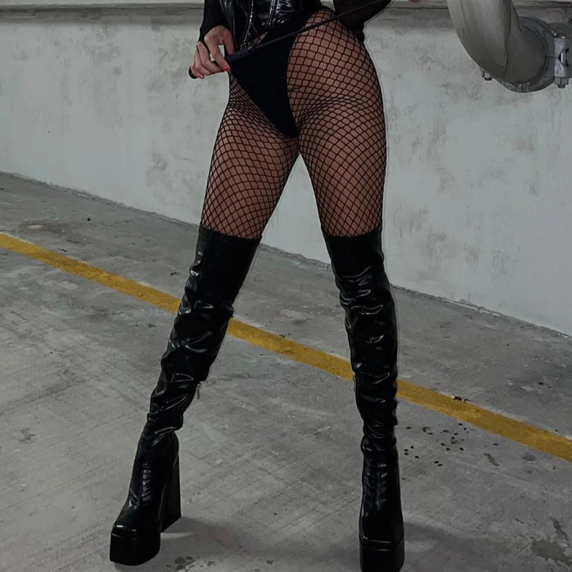 Black fishnet tights with black thigh garters and wide waistband