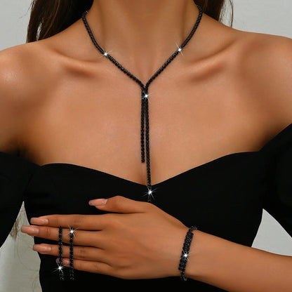 Auvexelle black beaded necklace with star-like pendant; matching bracelets