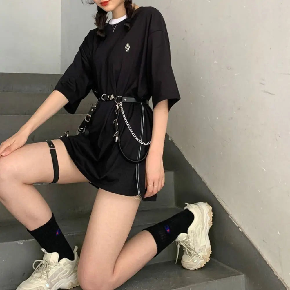 Black short dress with chain harness belt and ringed strap accents