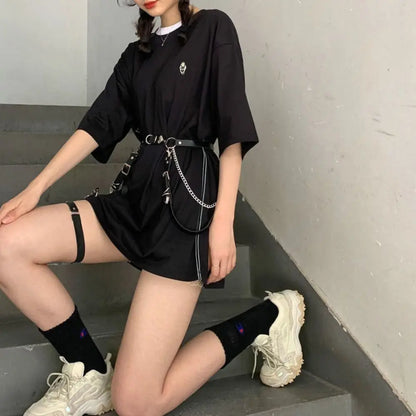 Black short dress with chain harness belt and ringed strap accents