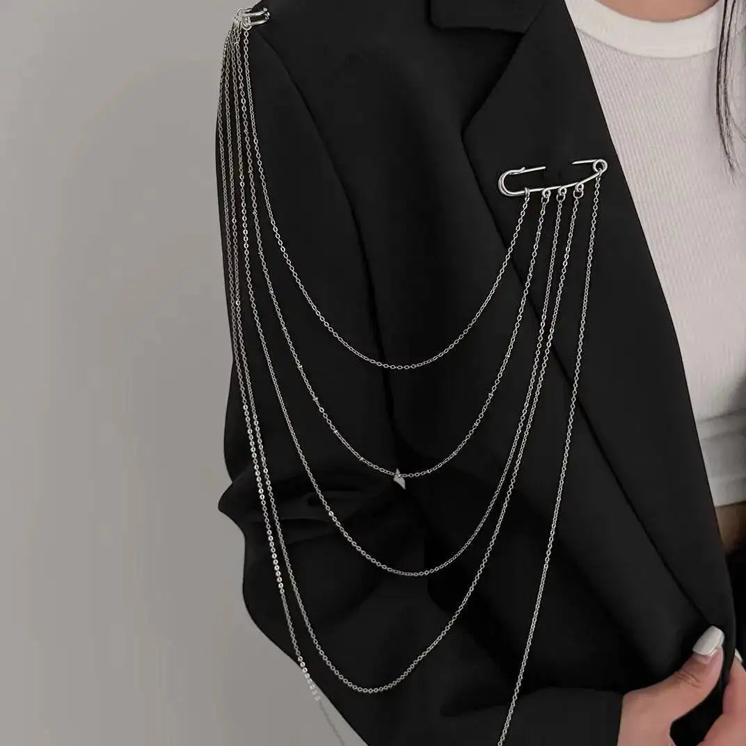 Layered silver chain drape necklace with five curved strands over a dark blazer