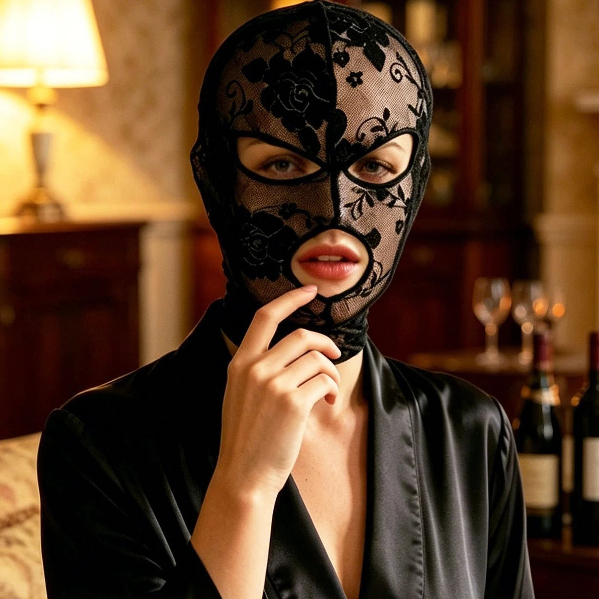 Black lace face veil mask with eye cutouts, worn over a black satin neckline