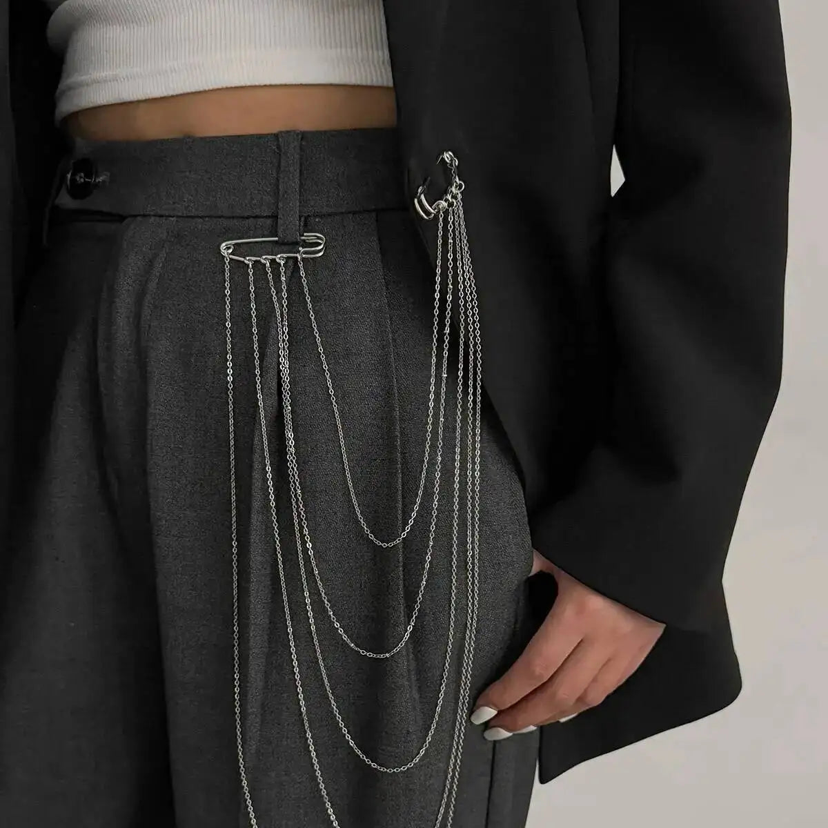 Layered silver chain drape belt with multiple hanging loops and clasp at waistband
