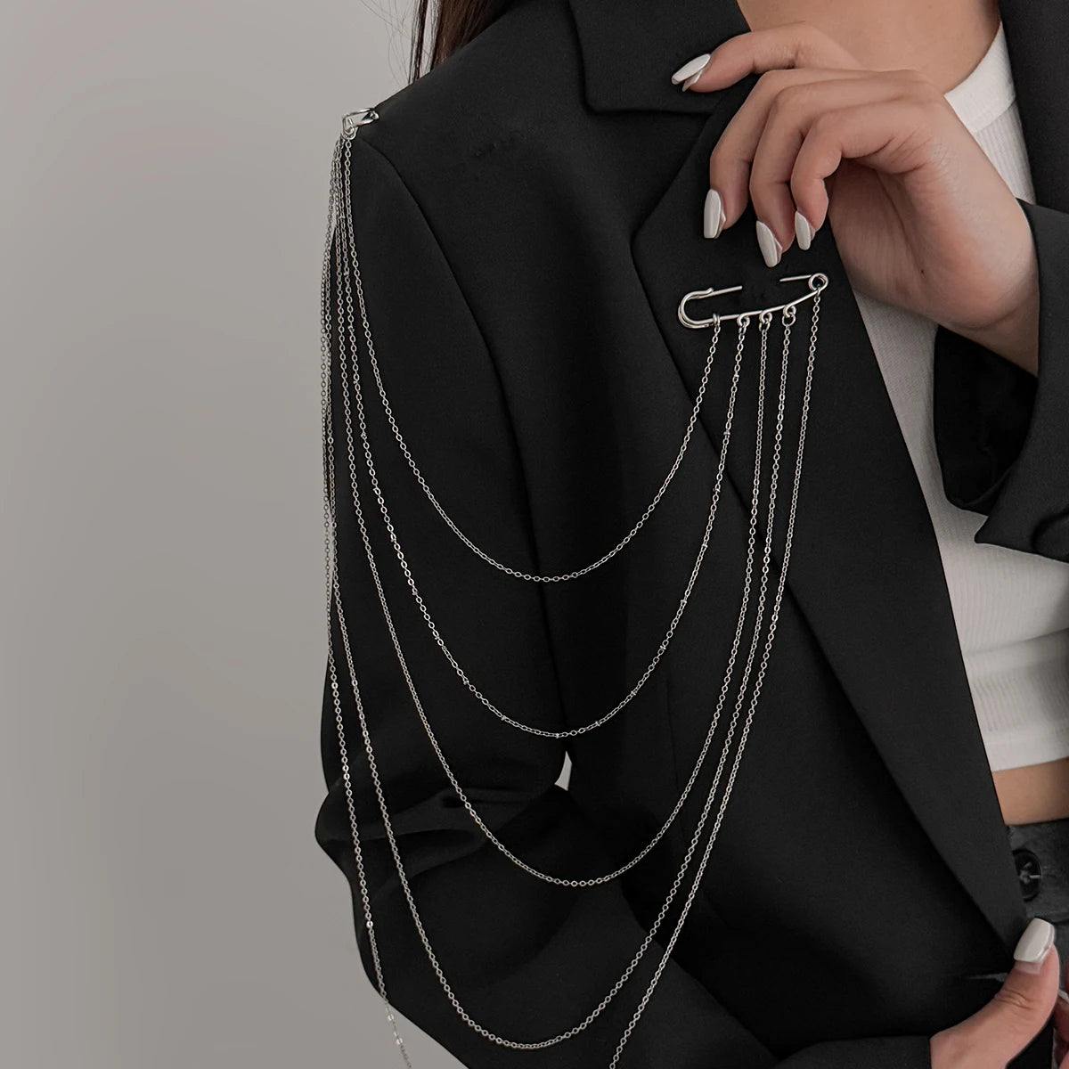 Layered silver chain drape necklace with multiple hanging loops and clasp detail