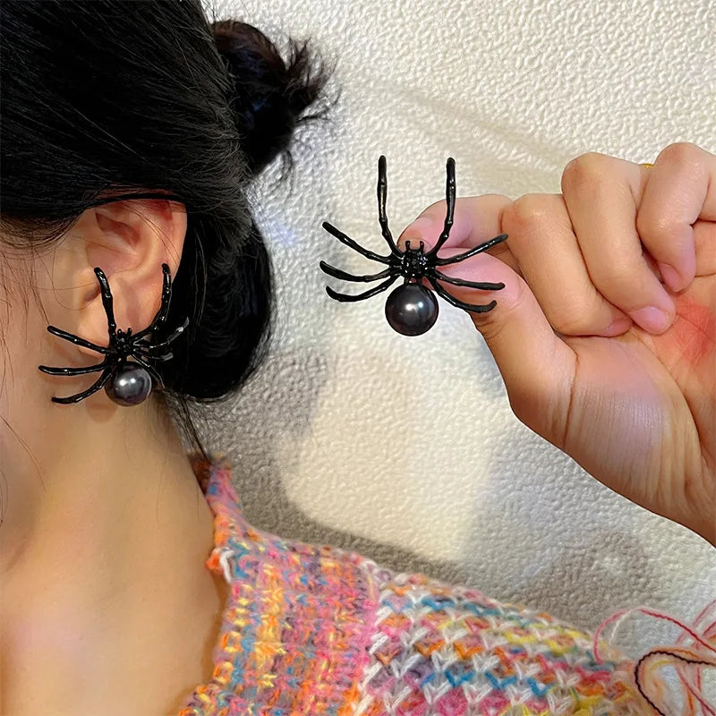 Pair of black spider pearl earrings with round bead and long legs