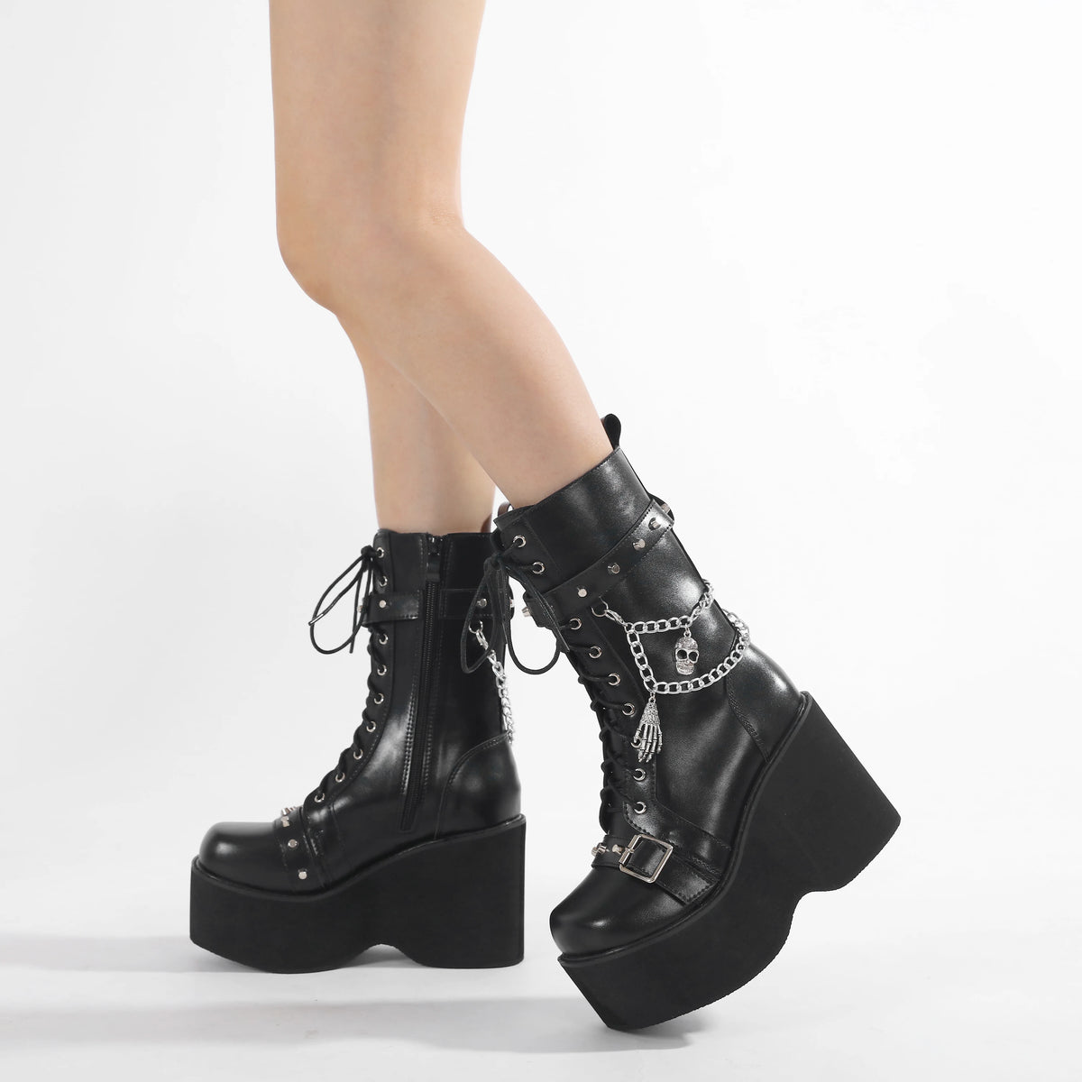 Black lace-up platform boots with side buckle strap and silver chain accents