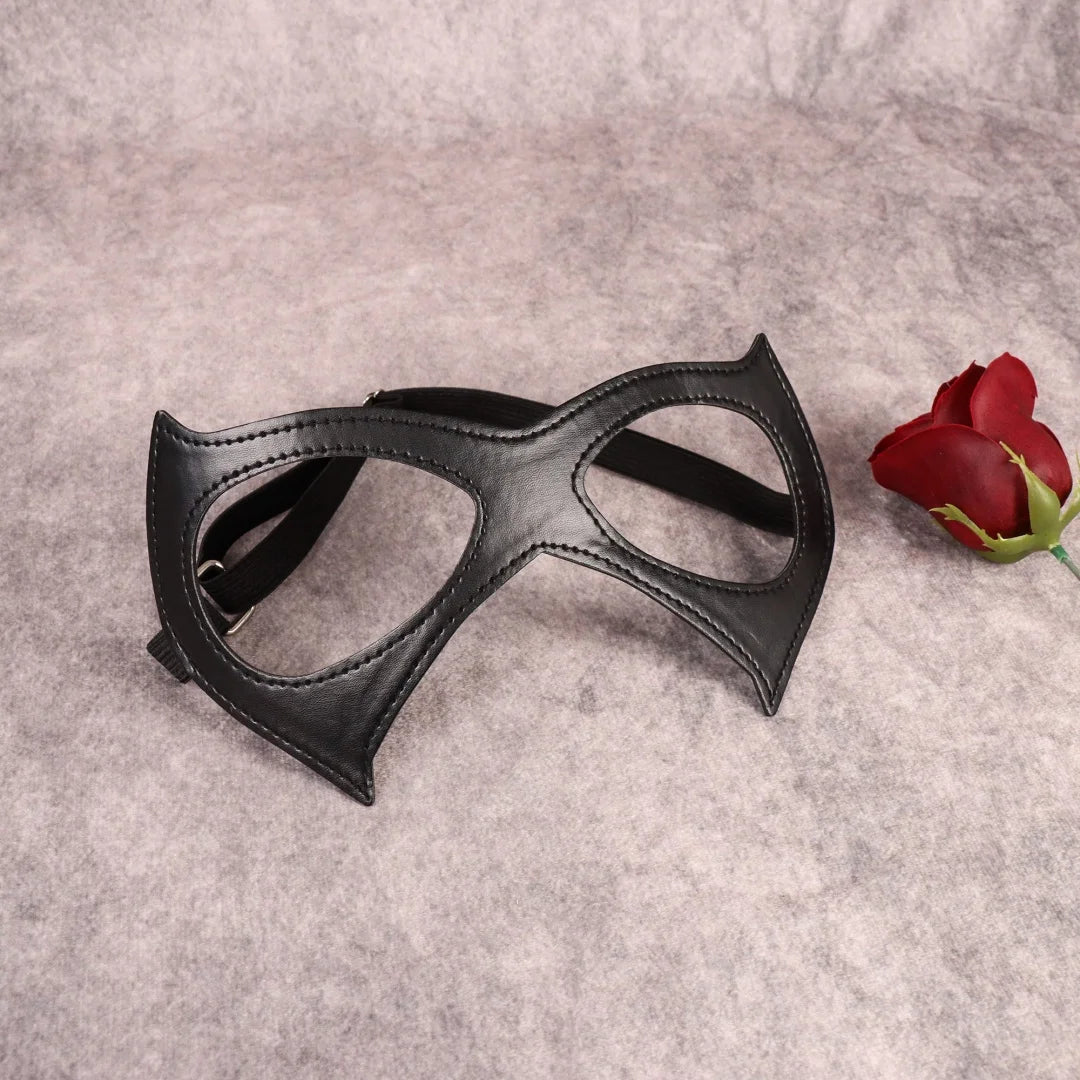 Black cat-eye mask with pointed cheek panels and open eye cutouts, elastic straps