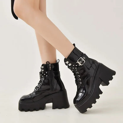 Black lace-up platform boots with rivet straps and chunky lug sole