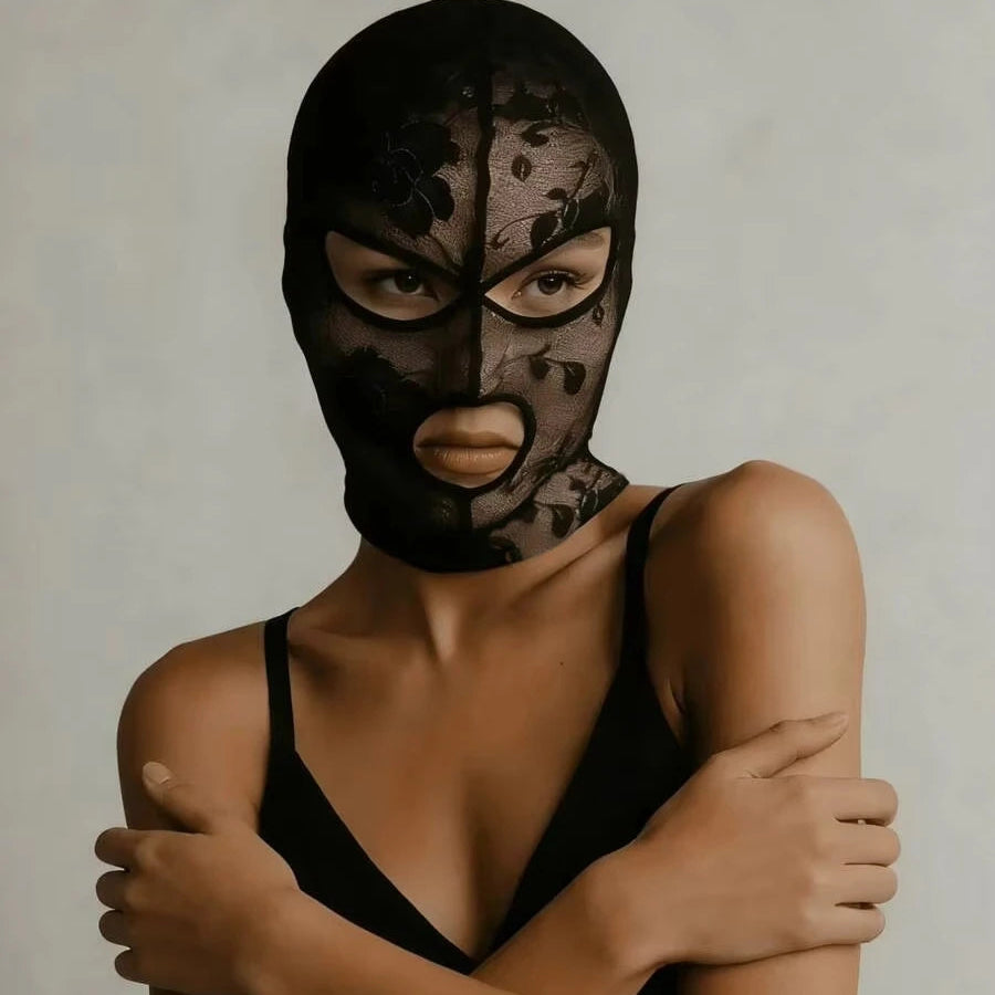 Black lace face veil mask with eye and mouth openings, shown from shoulders up