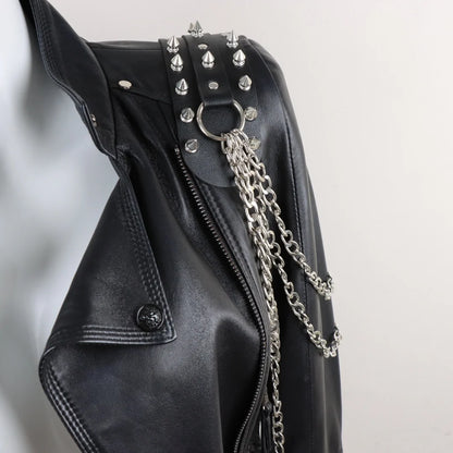 Darkvolt leather harness with spiked studs, O-ring hardware, and long layered chain straps