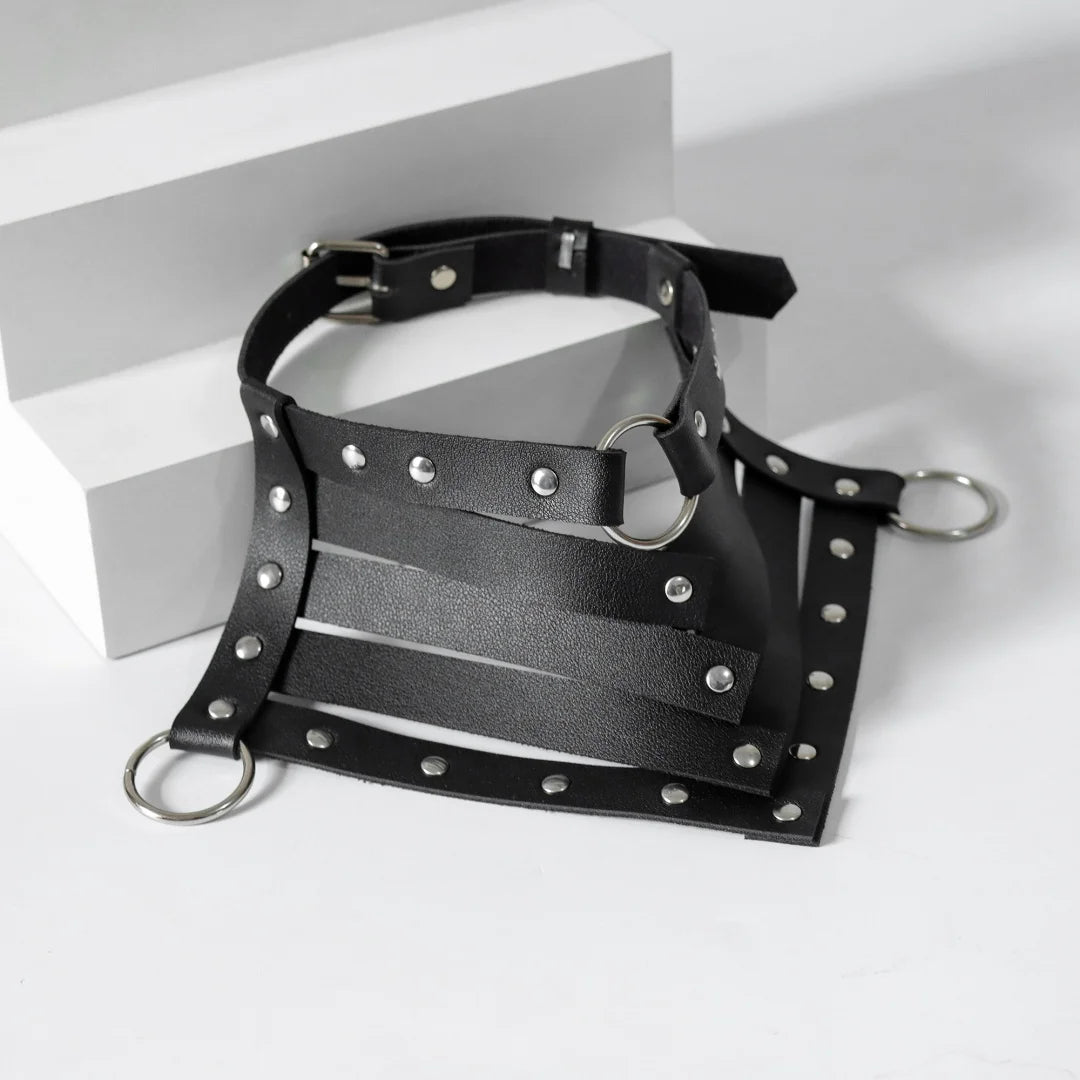 Black leather choker harness with silver studs, wide strap panels, and rings