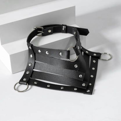 Black leather choker harness with silver studs, wide strap panels, and rings