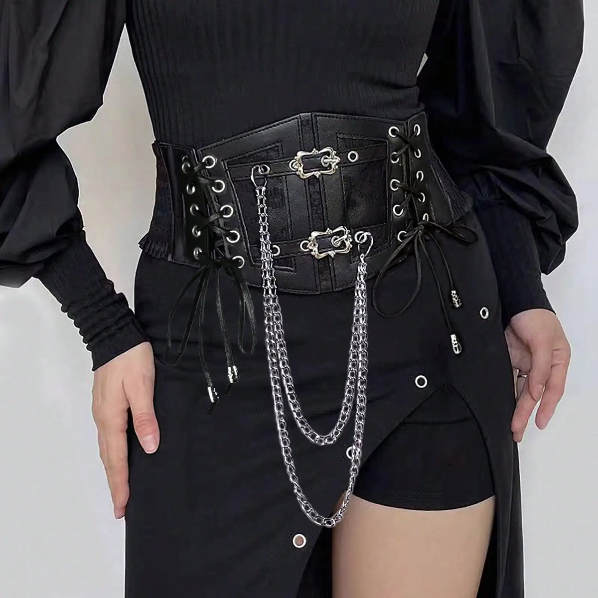 Dark lace-up cincher belt with grommets, buckles, and hanging chain straps