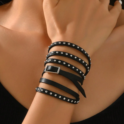 Close-up of black studded cuff bracelet with silver square buckle