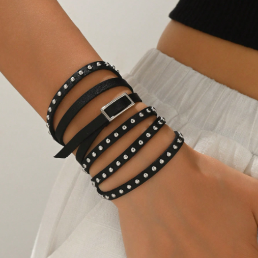 Black leather wrap bracelet with silver studs and square buckle on wrist