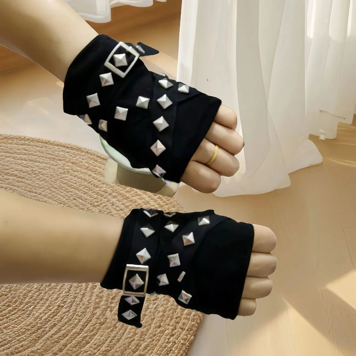 Black studded wrist warmers with silver pyramid studs and dangling tie straps