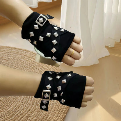 Black studded wrist warmers with silver pyramid studs and dangling tie straps
