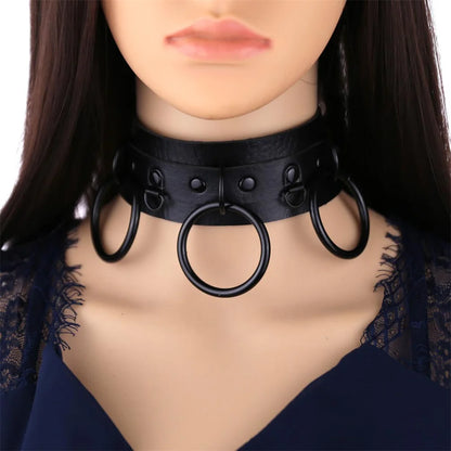 Black gothic choker worn on neck with studded band and three O-rings