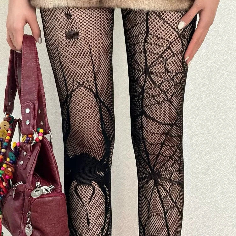 Black sheer tights close-up with webbing and heart prints on the legs