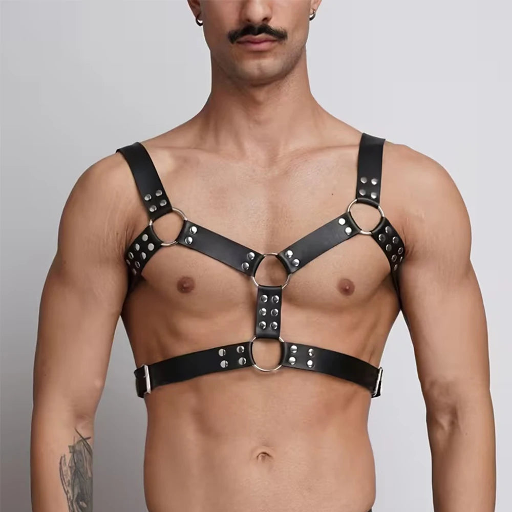 Black chest belt harness with metal rings, stud accents, and cross-strap design