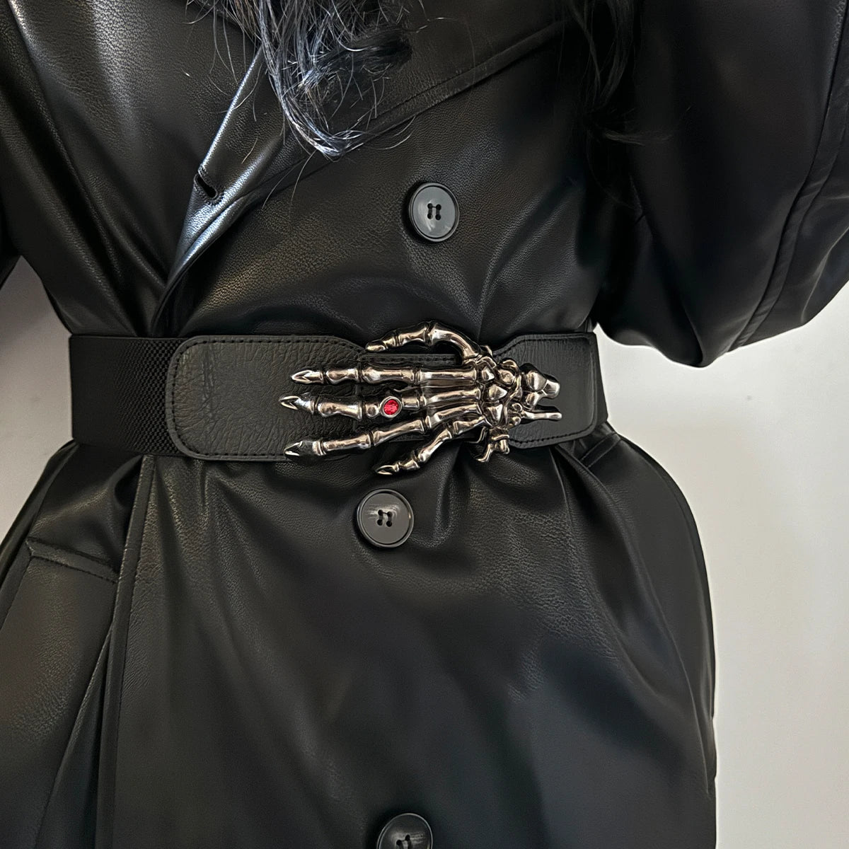 Leather belt with silver skeleton-hand buckle and red gem, dark color