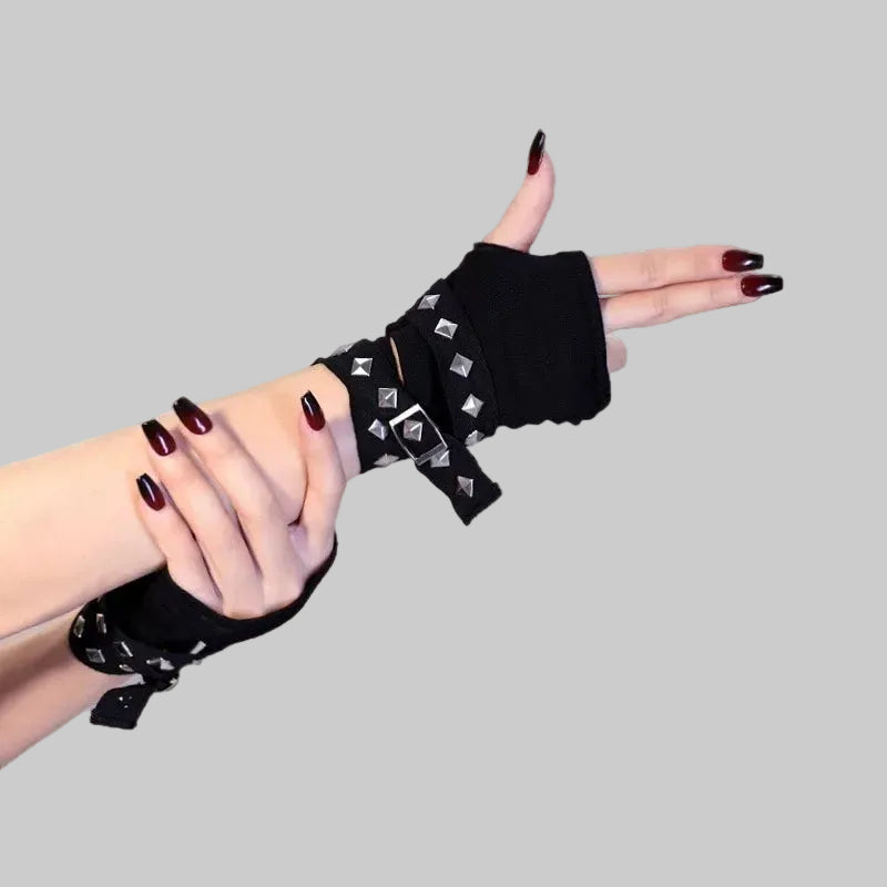 Black fingerless wrist warmers with silver pyramid studs and crisscross wrap straps