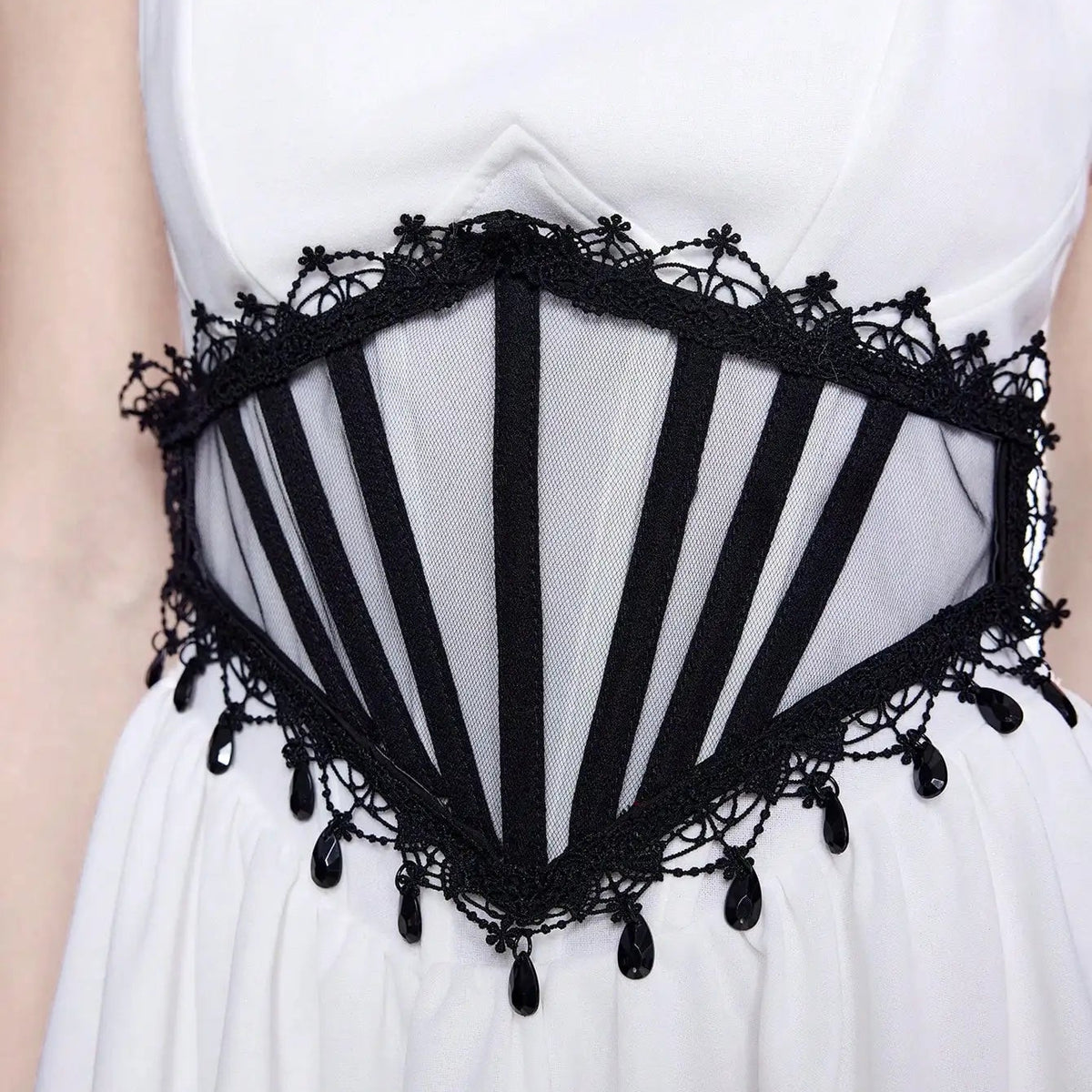 White dress with black lace waist cinch, striped mesh and dangling trim