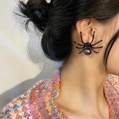 Black spider pearl ear cuff with round gray bead on model hair