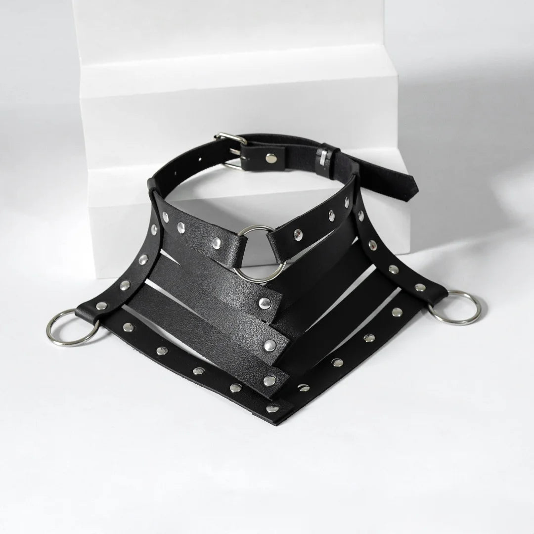 Black leather neck harness with silver studs, metal rings, and adjustable buckle