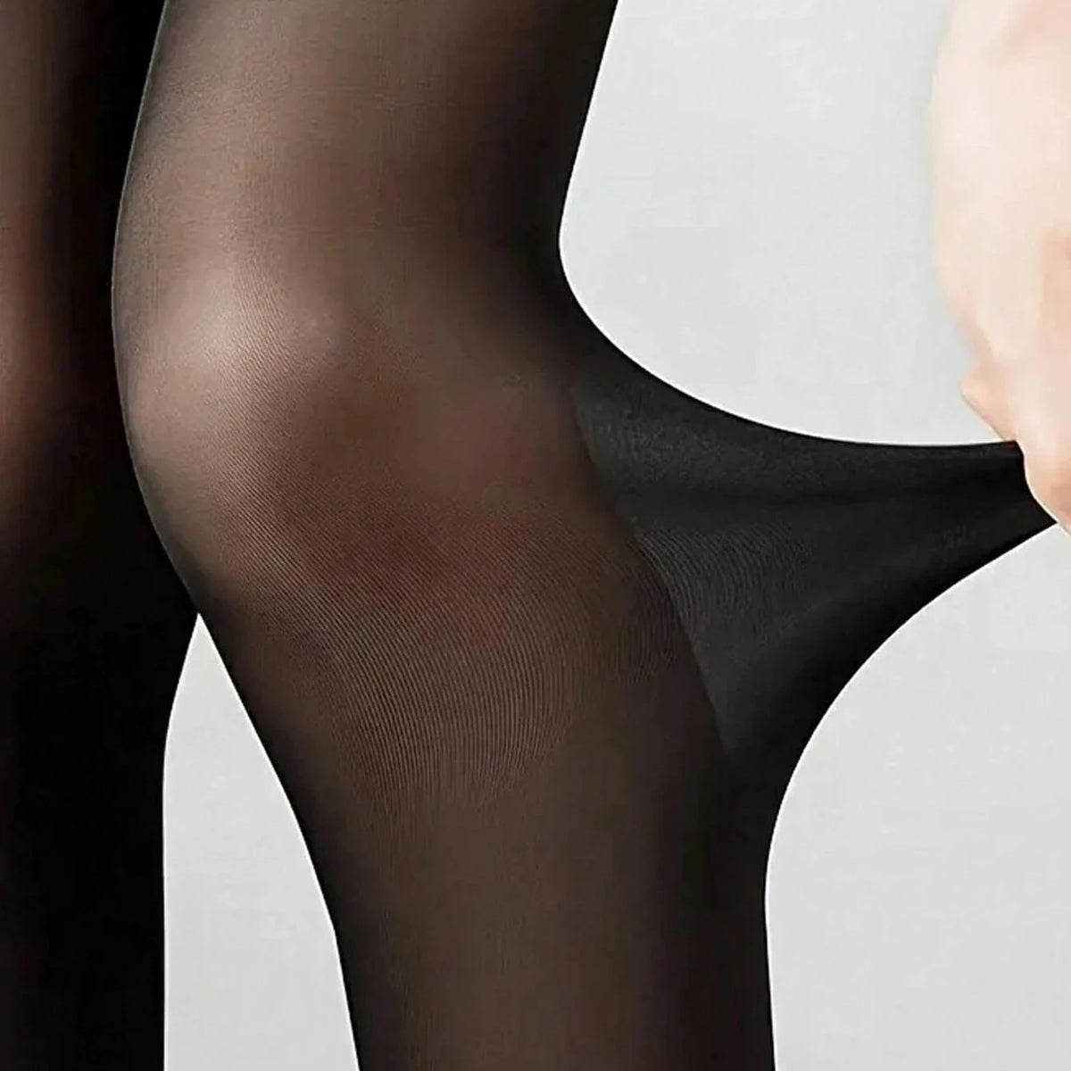 Close-up of black sheer stocking fabric with fine knit texture