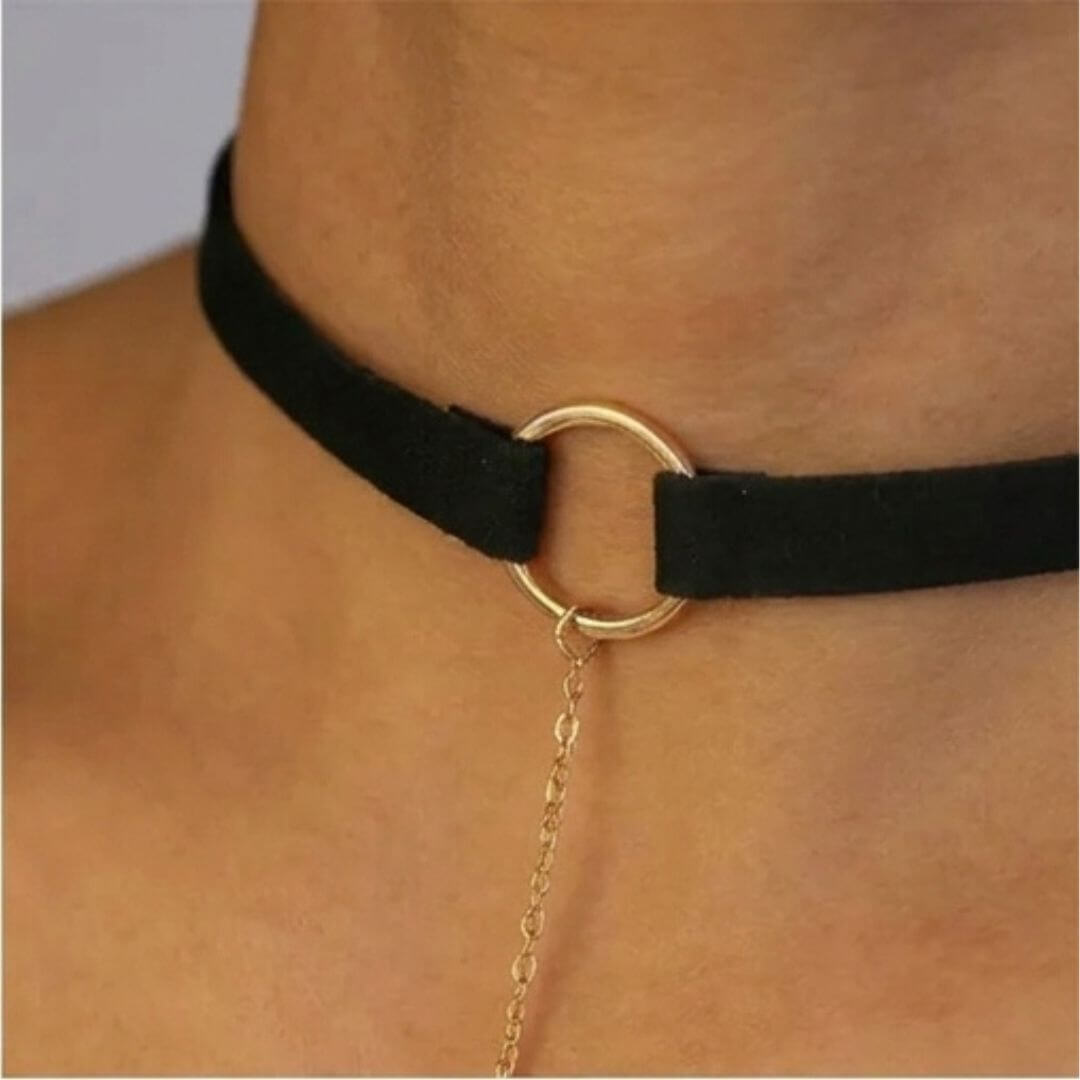 Black velvet choker with gold-tone ring clasp and chain leading to bar pendant