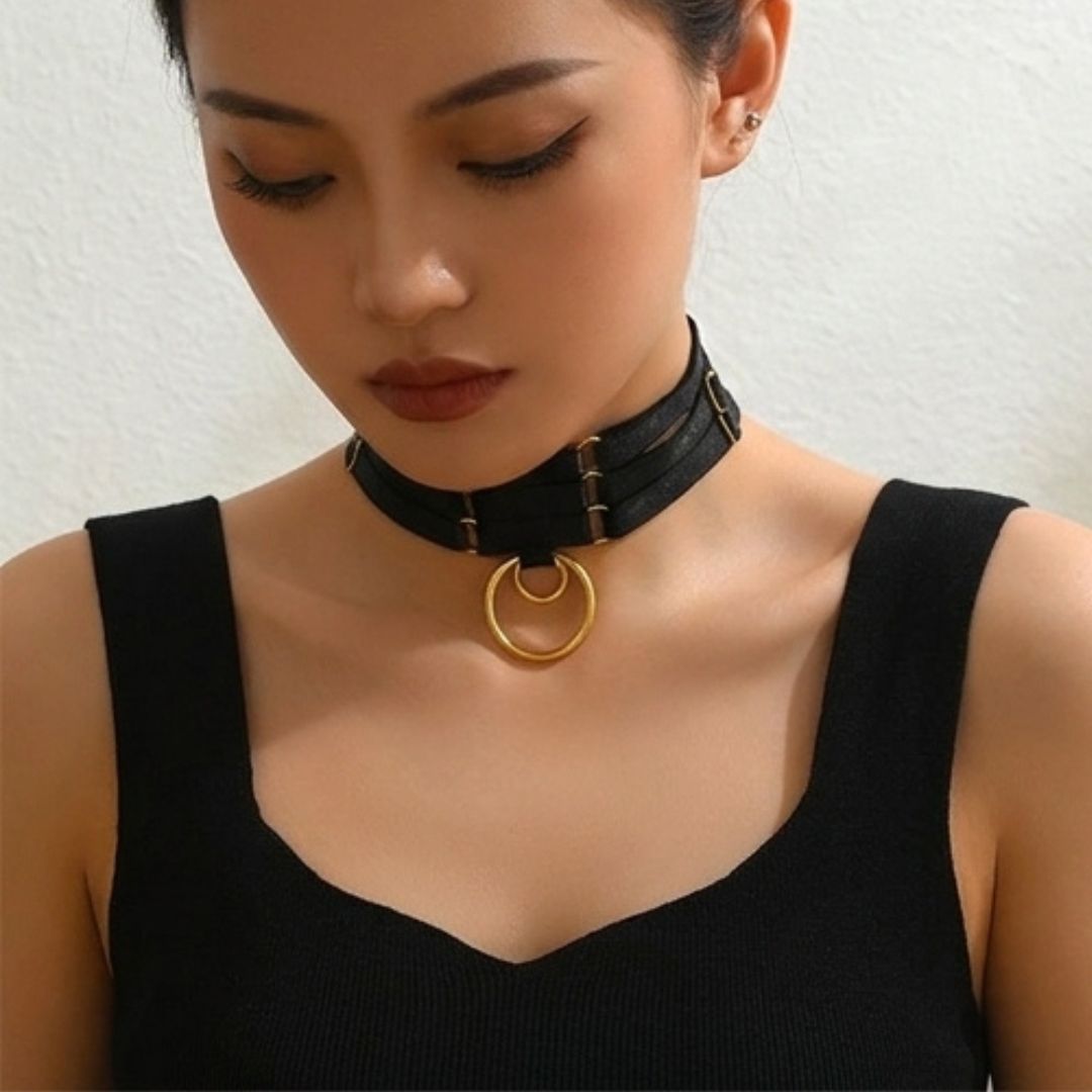 Black triple-ring choker with gold circular ring center and triple strap bands