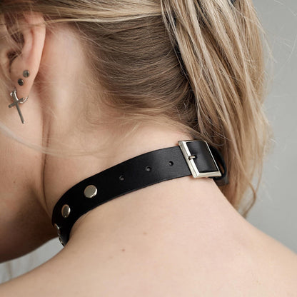 Black leather choker with silver buckle closure and metal studs