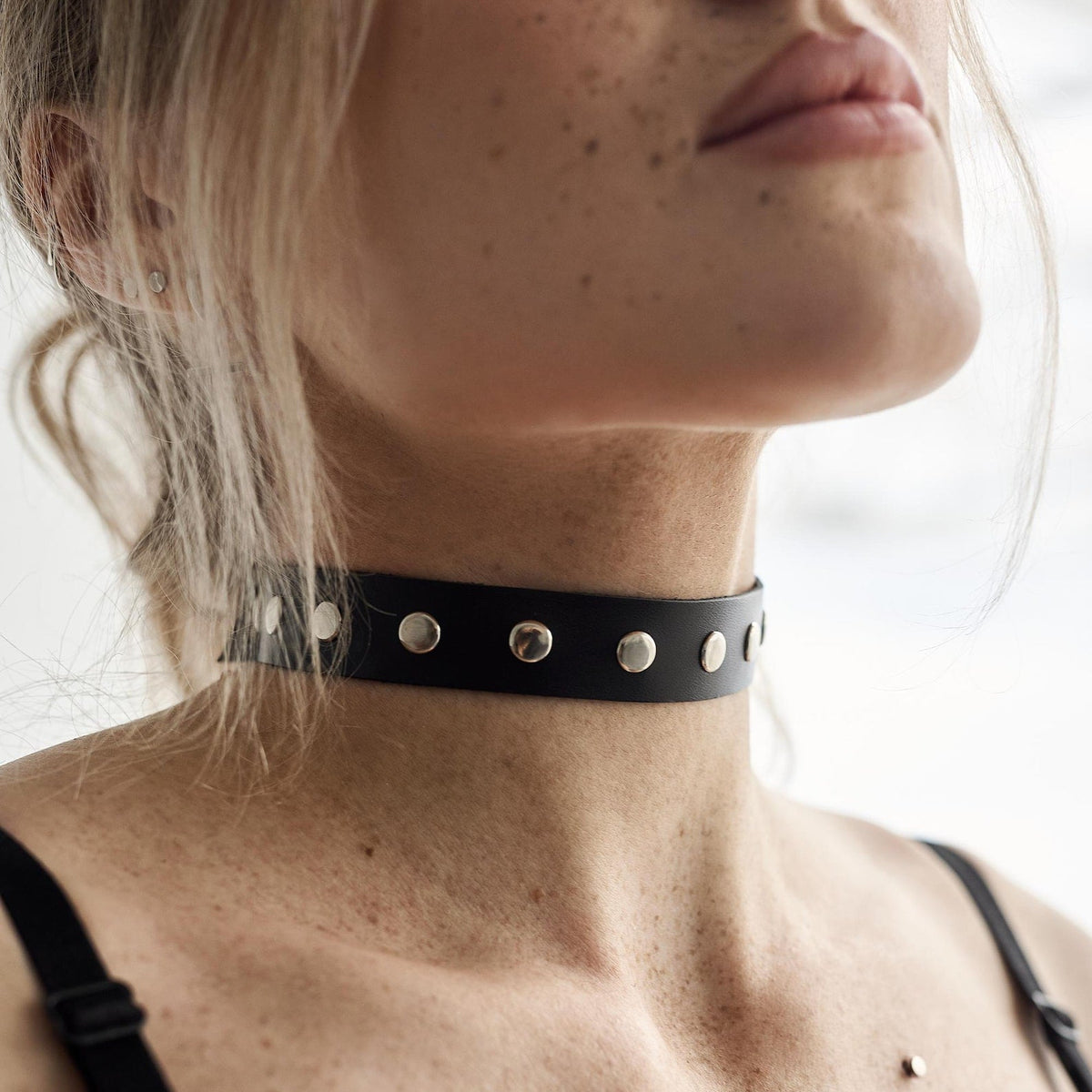 Black choker with metal grommets and eyelets, adjustable fit